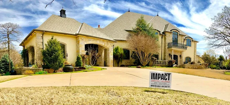 Large stucco home with a completed architectural shingle roof