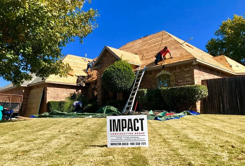 Roofers removing shingles from a single-story brick home