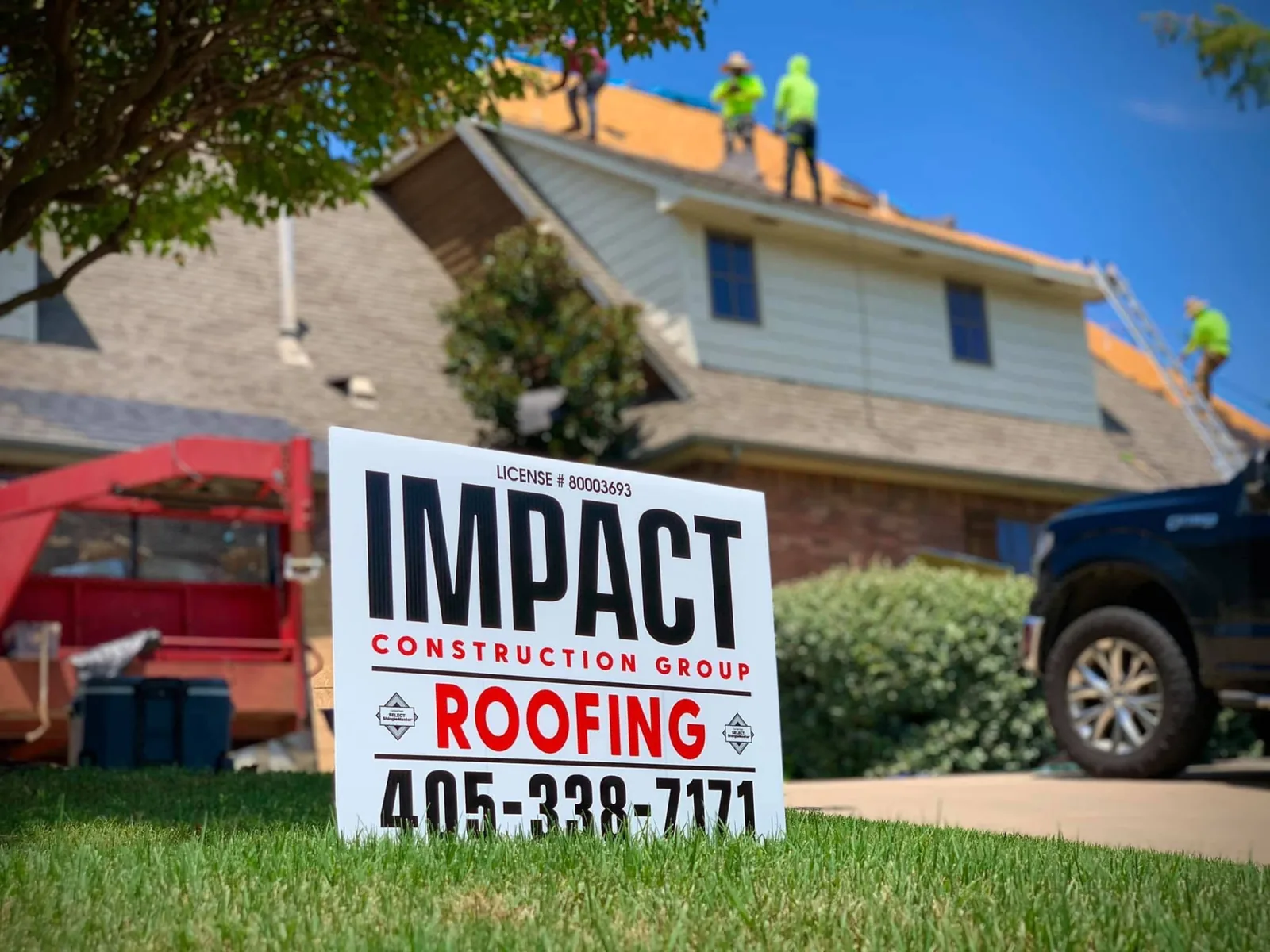 Impact Construction roofing sign in front of an active home roof replacement