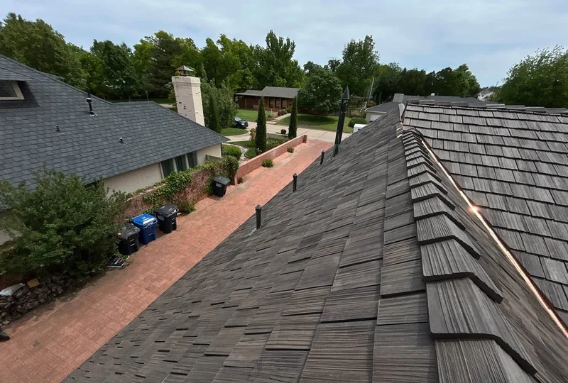 Close view across a completed dark synthetic shake roof